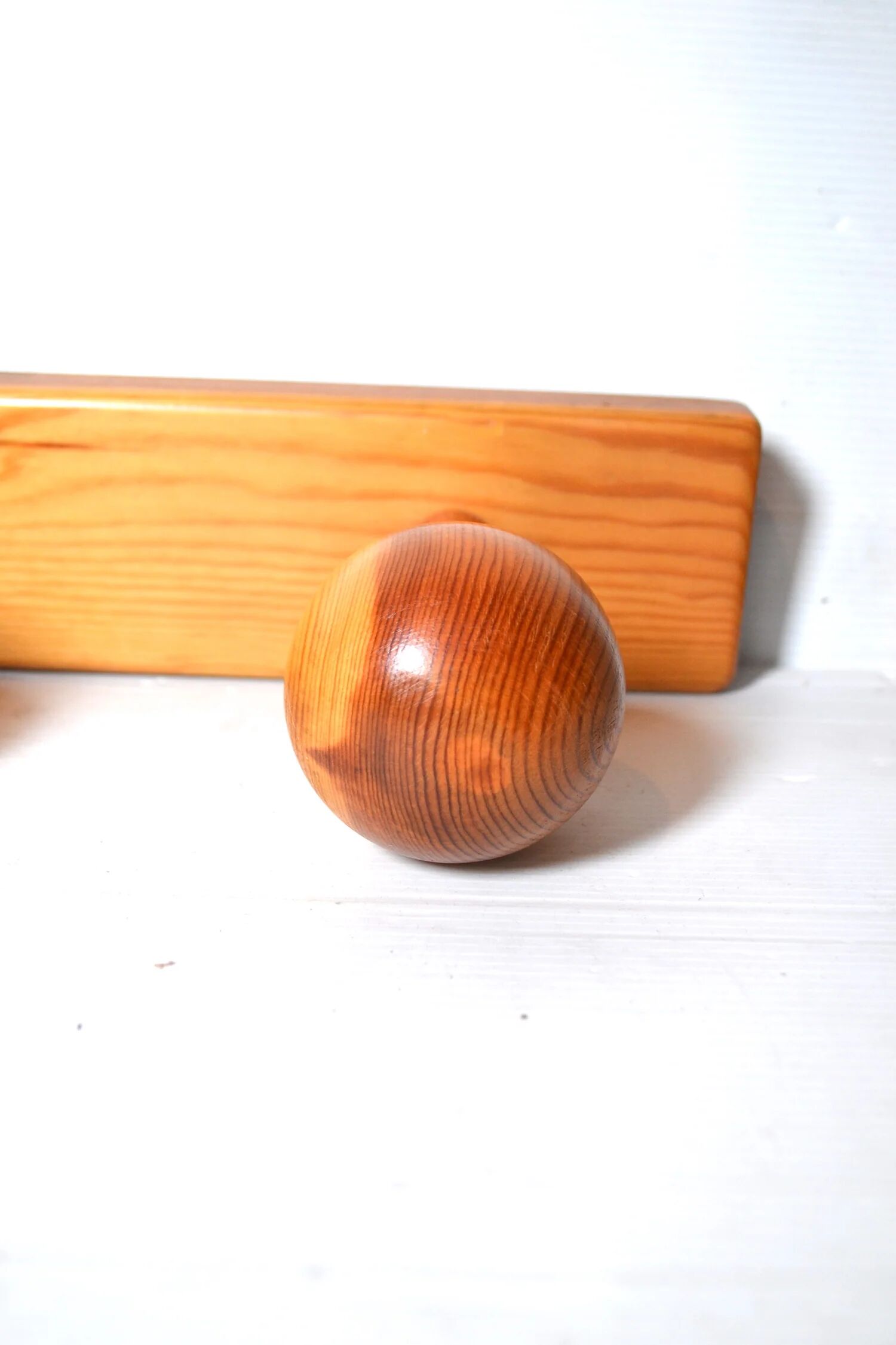 Vintage wall-mounted coat rack in solid pine.