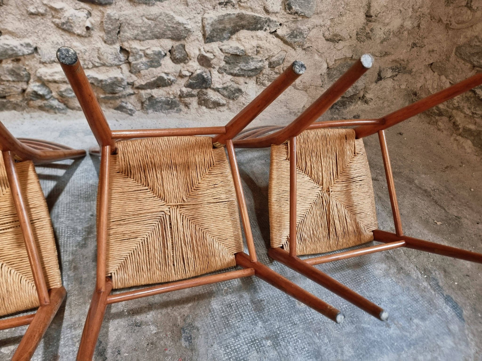 Set of 4 mid-century Italian dining chairs with woven seats, circa 1950–1970.