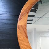 Round mirror in varnished pine