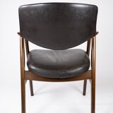 Armchair in rosewood and black leather of danish design from 1976.