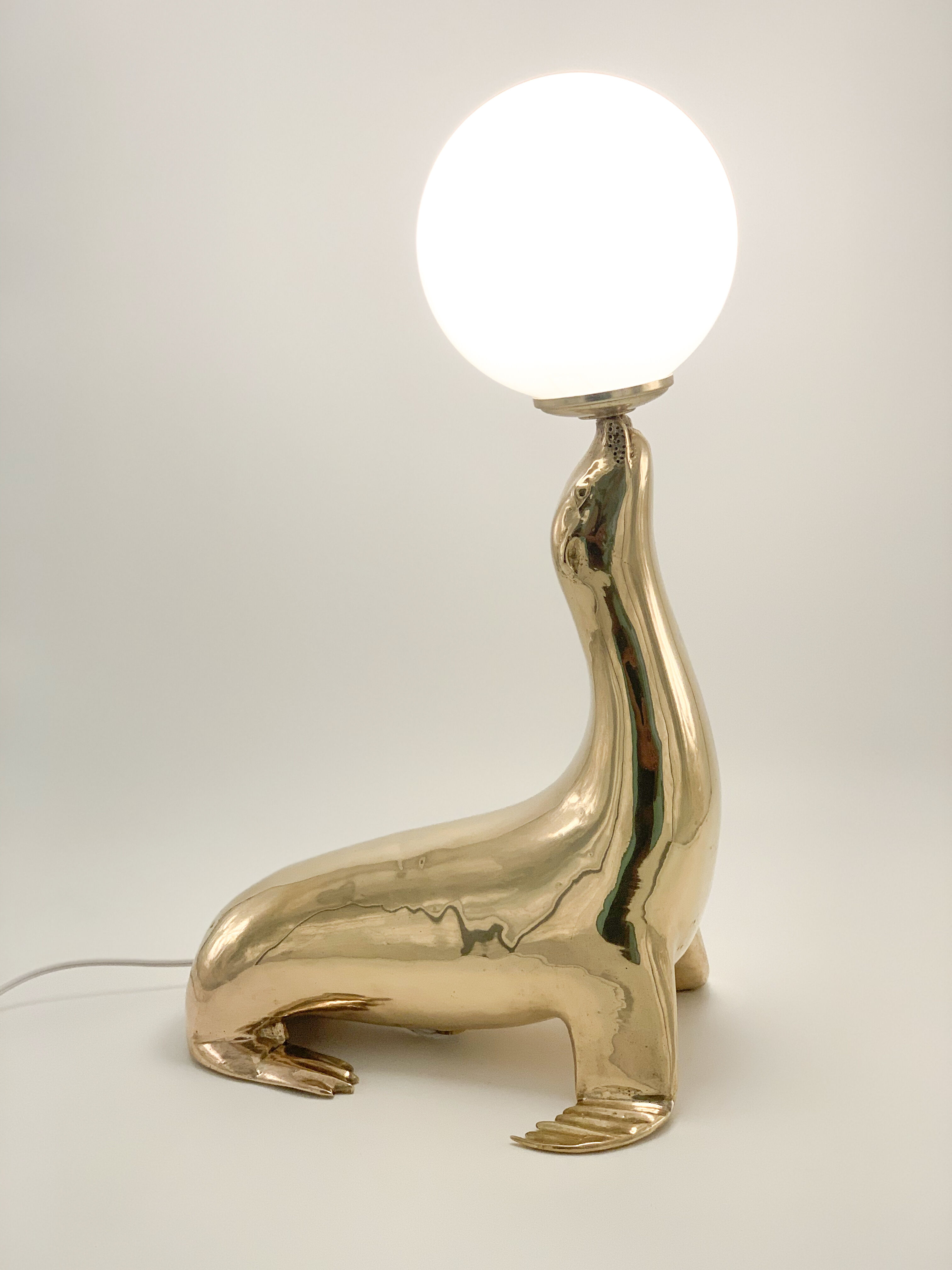 Vintage brass sea lion lamp