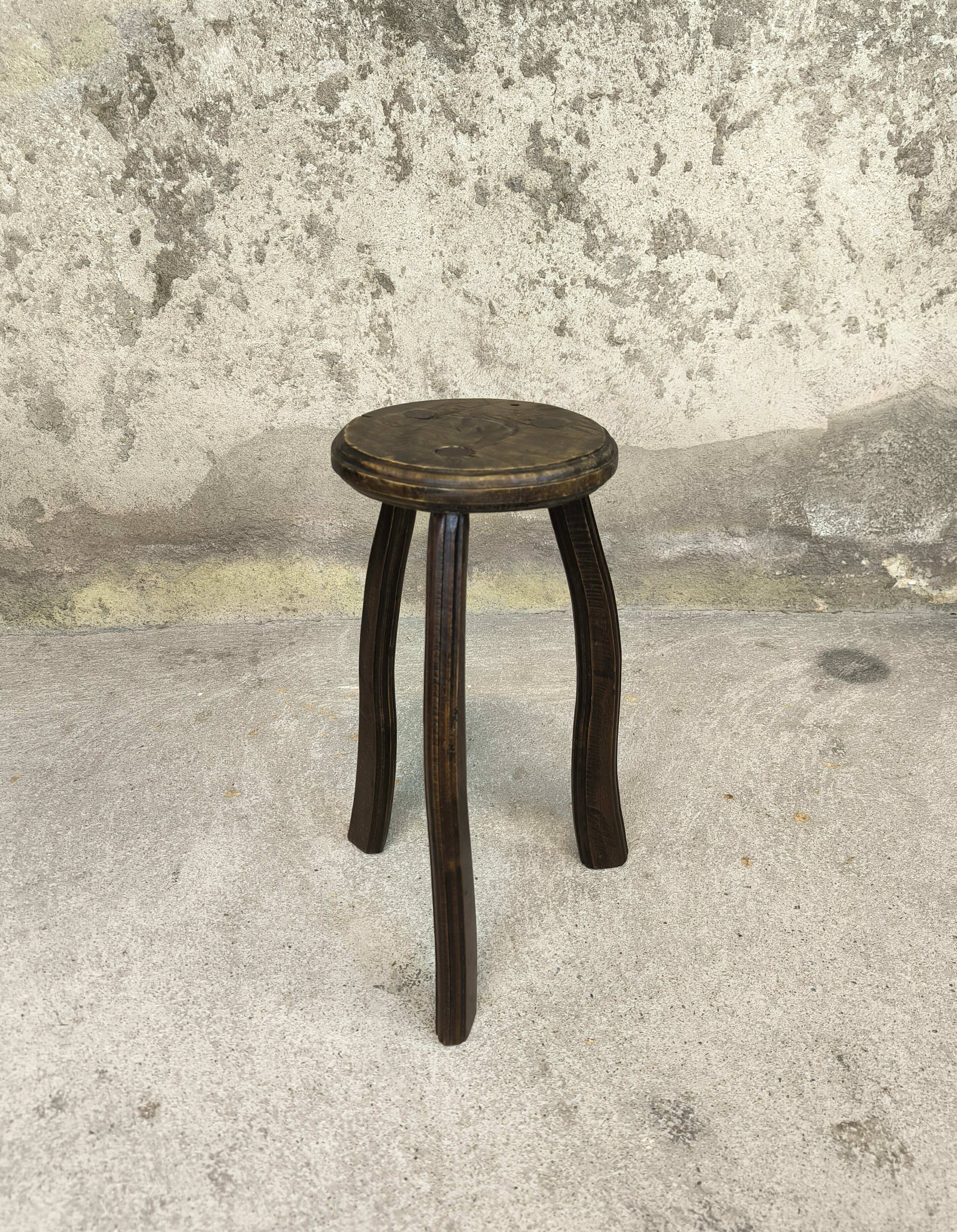 Vintage tripod plant stand with curved legs.