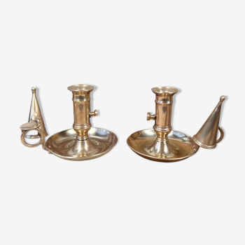 Duo of brass cellar rat candlesticks with extinguisher