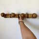 Antique wall-mounted coat rack in turned bamboo-style wood