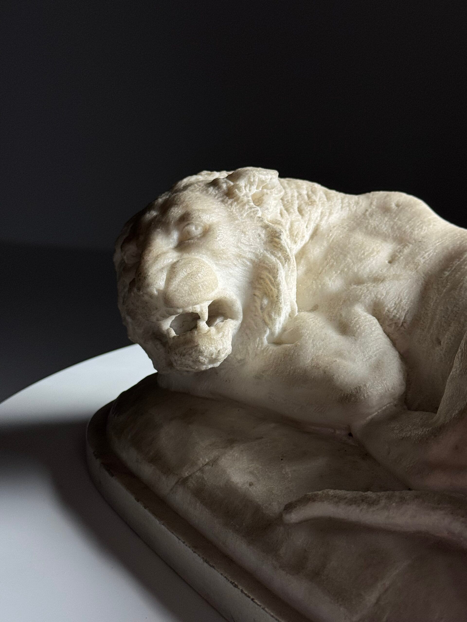 Marble sculpture of a reclining lion
