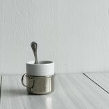 2 porcelain cups with metal supports and small spoons.
