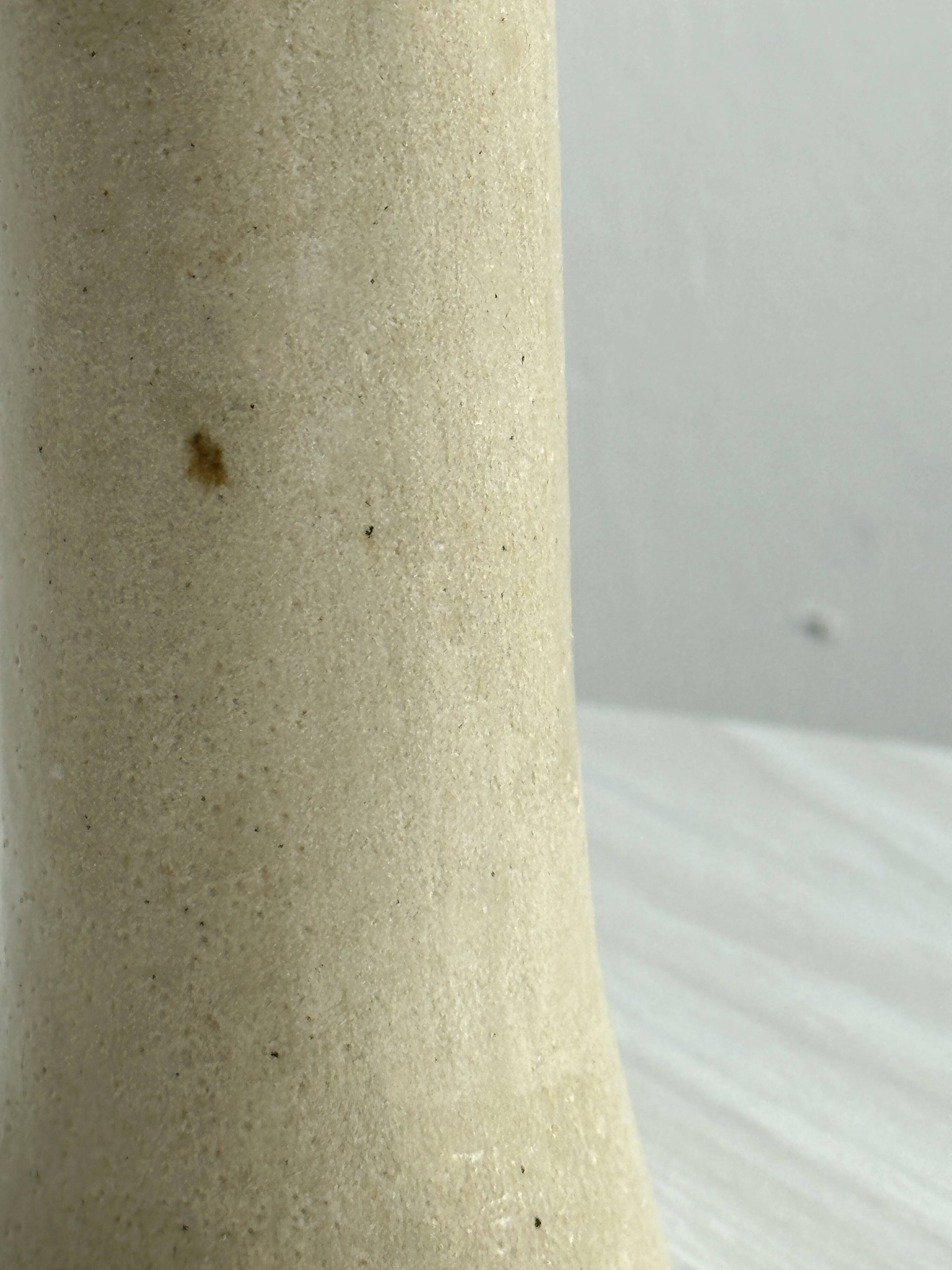 Minimalist beige ceramic vase.