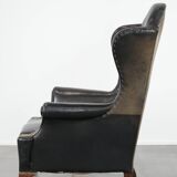 Antique black English cow leather wingback armchair from the 19th century