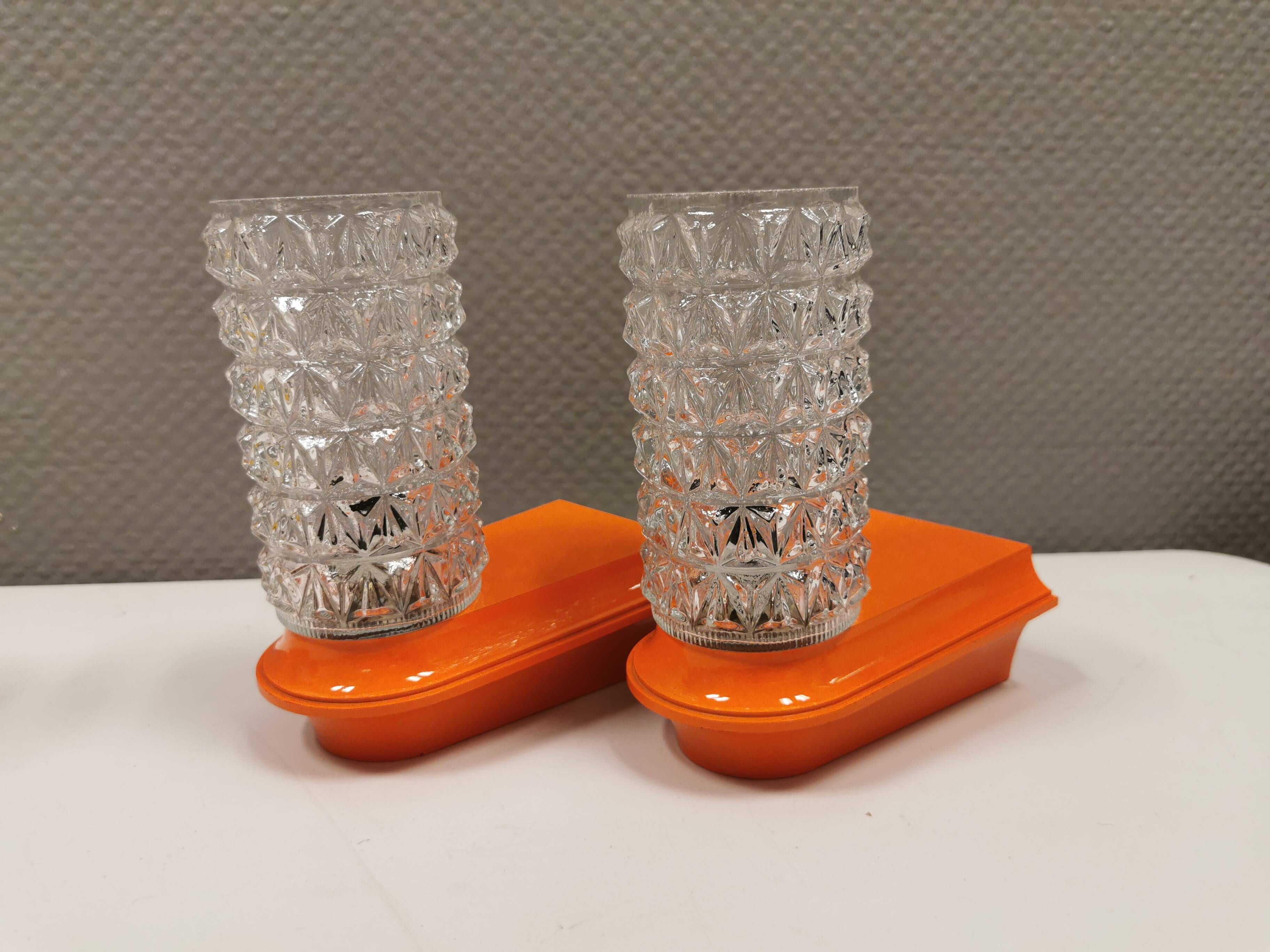 Bathroom lamps in a nice orange colour with a crystal glass shade and a base of hard thin plastic