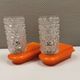 Bathroom lamps in a nice orange colour with a crystal glass shade and a base of hard thin plastic