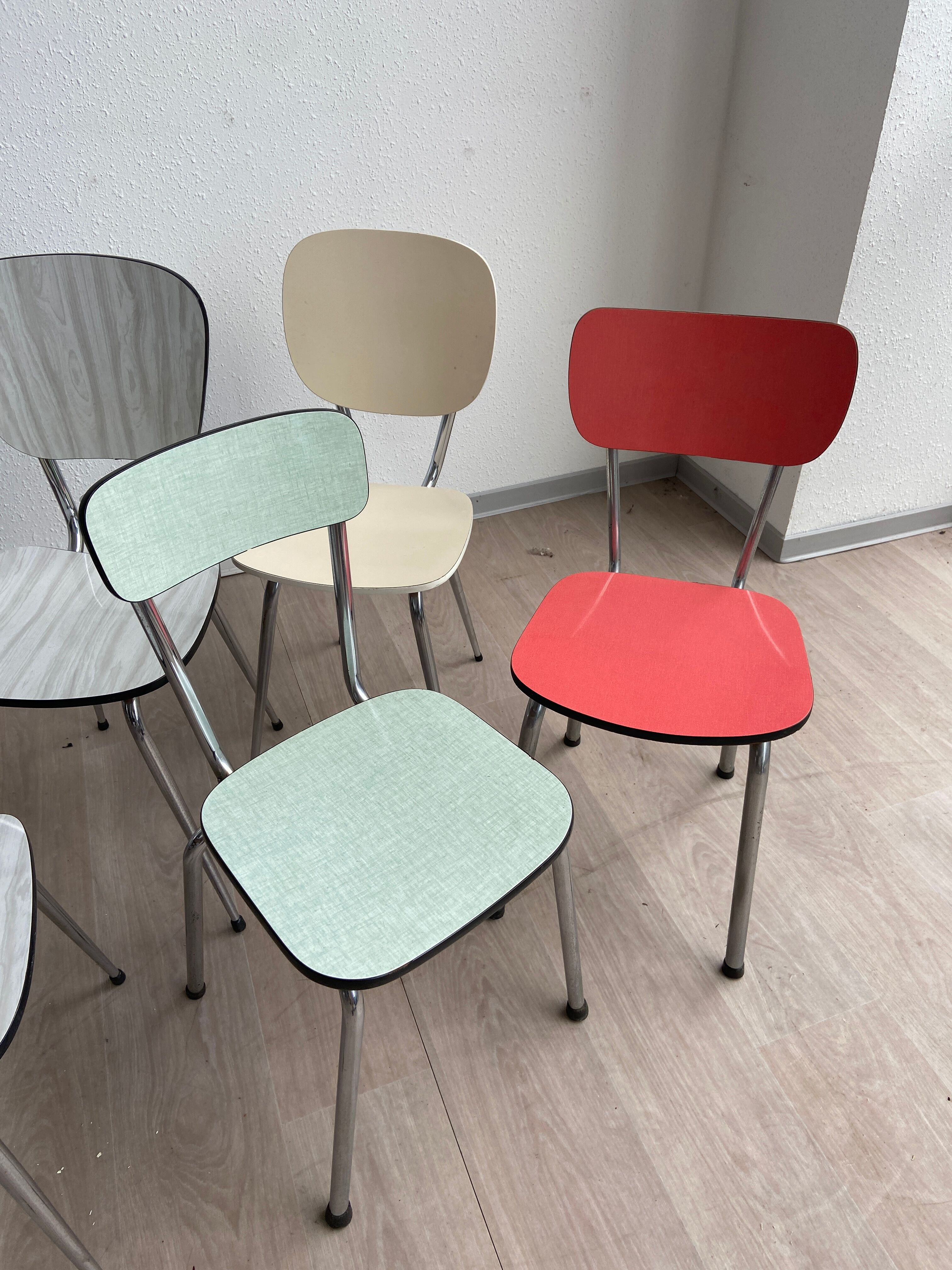 10 mismatched multicolored Formica chairs 60s