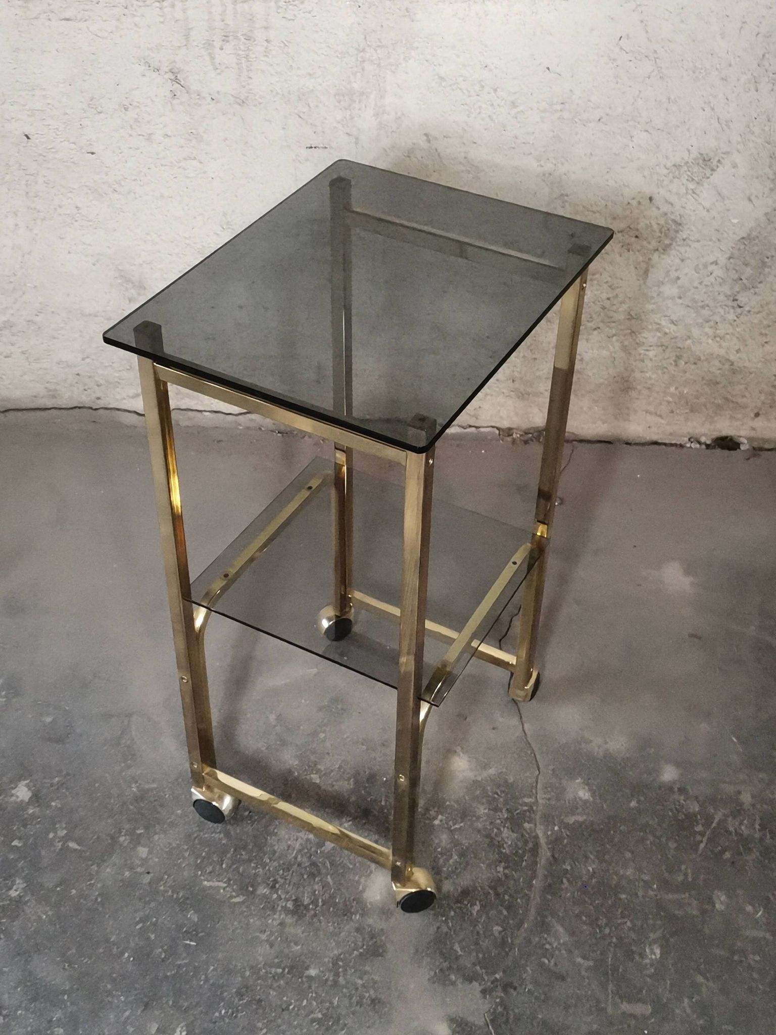 Side Table 1970s smoked glass/gold/wheels