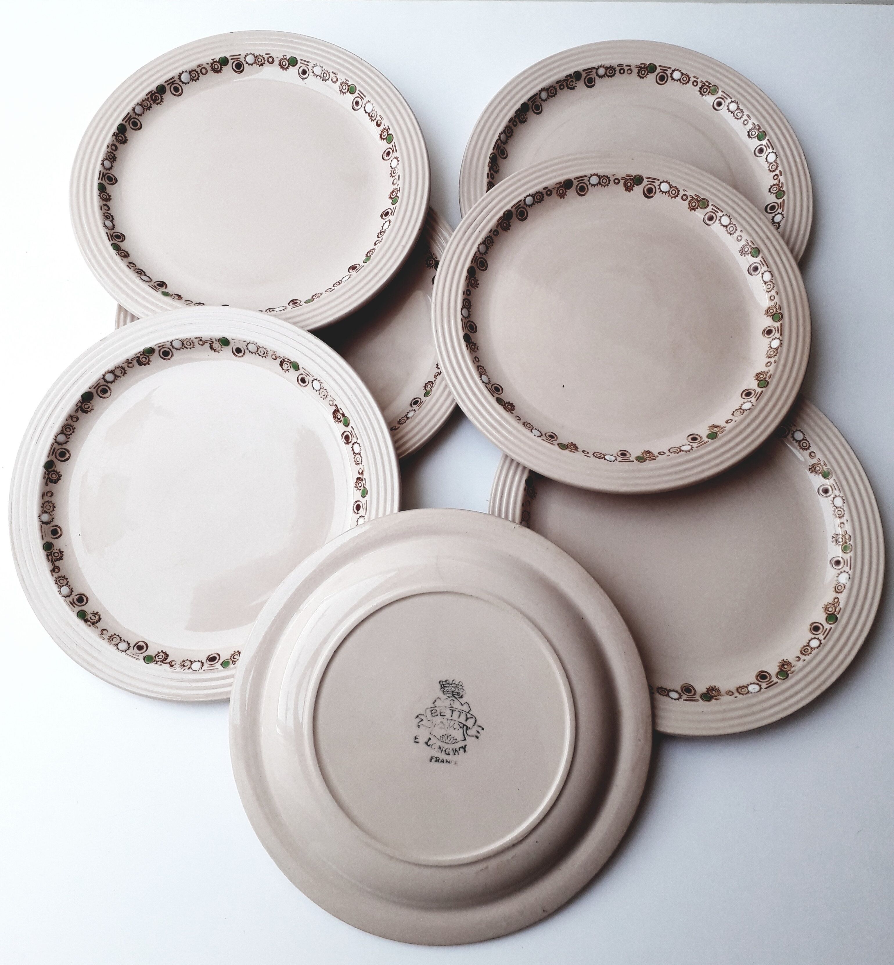 Set of 7 Betty Longwy model plates with floral decoration