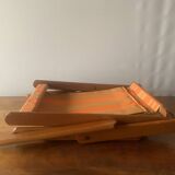 Old foldable beach seat in wood and canvas for children