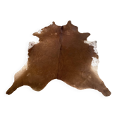 Brown and white cow rug