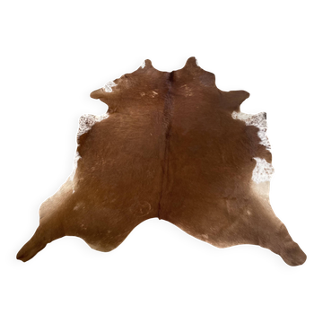 Brown and white cow rug