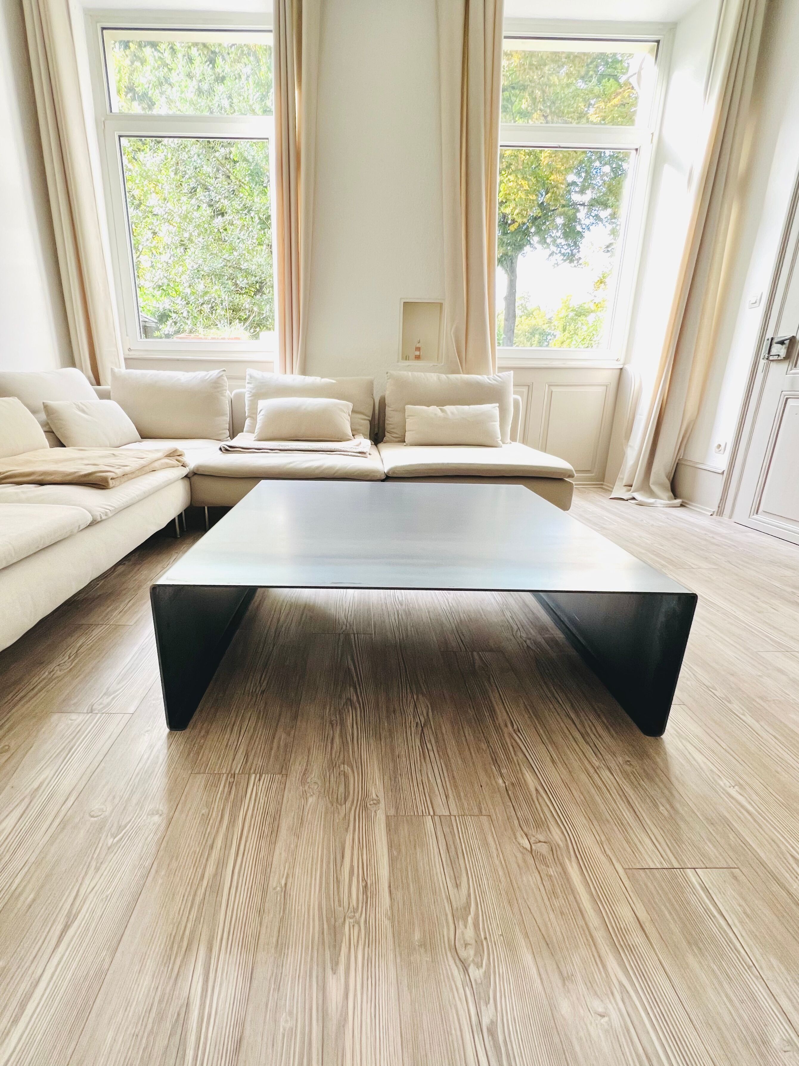 Coffee table with raw metal steel leaf.