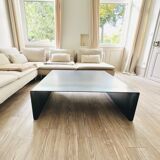 Coffee table with raw metal steel leaf.