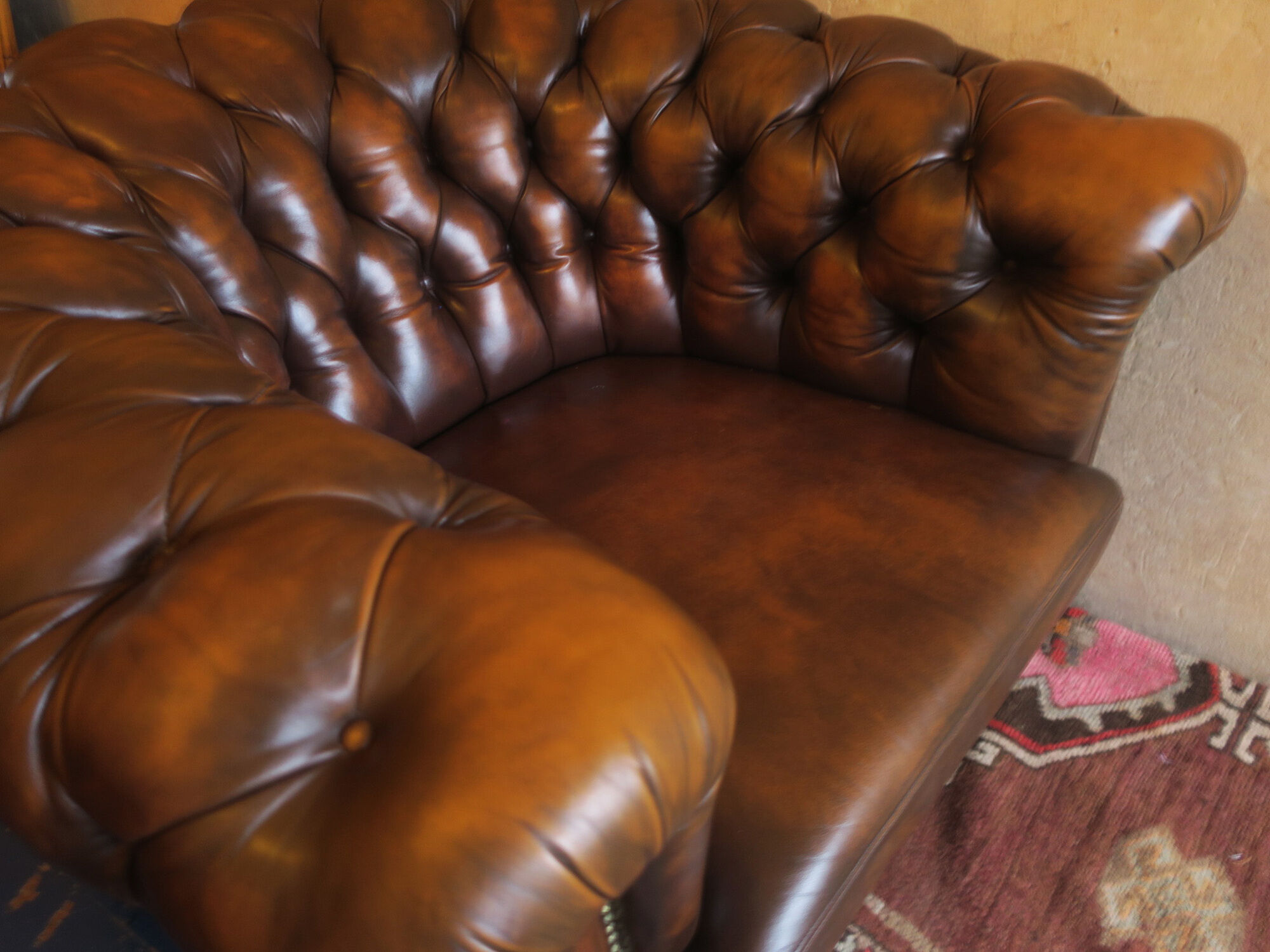 Chesterfield club armchair in patinated chestnut coloured leather