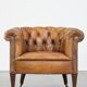 Antique, characteristic sheepskin chesterfield club chair on wheels