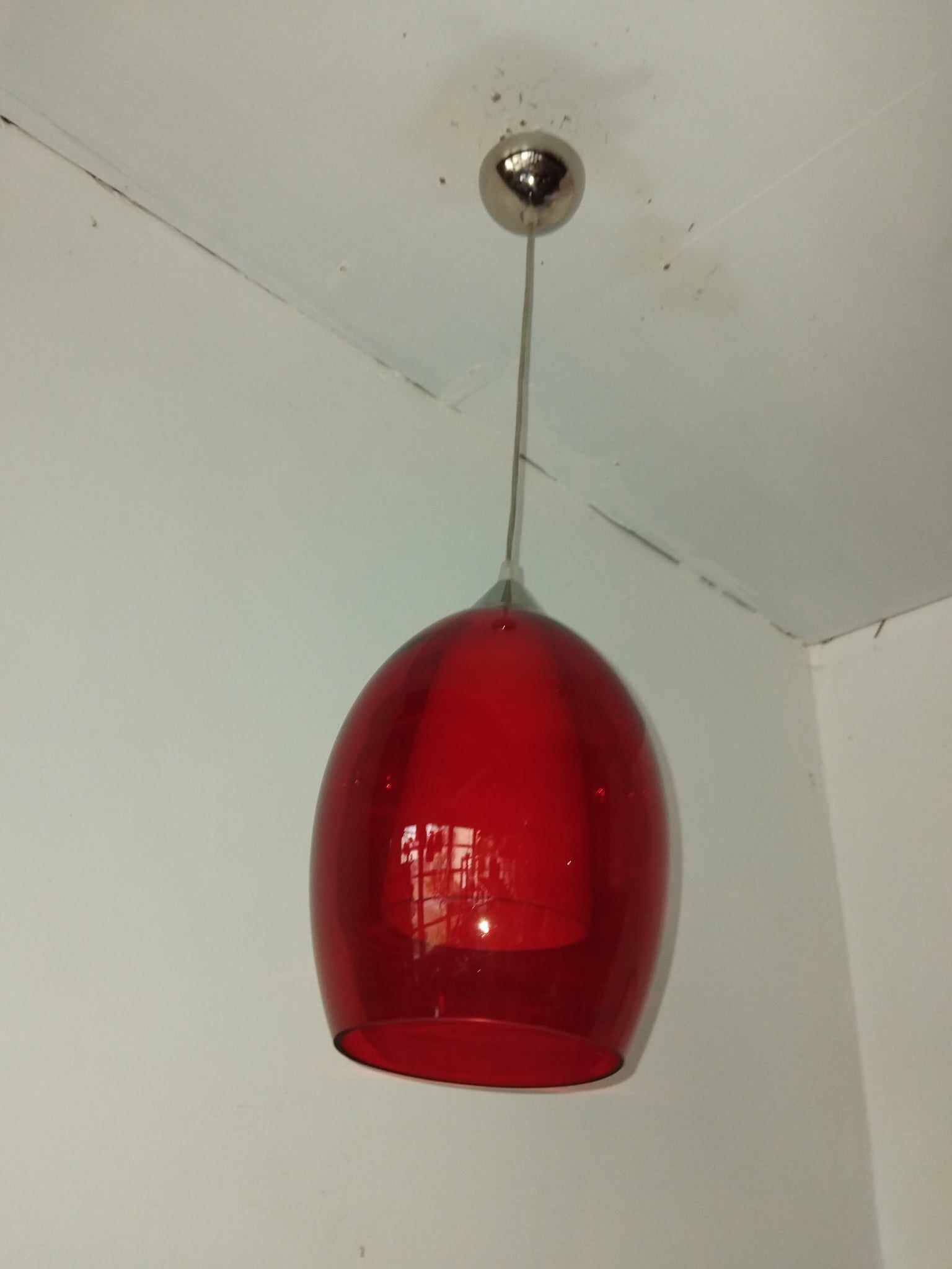Pair of conical pendant lights in red tinted glass