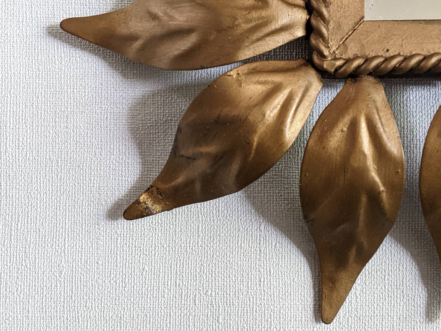 Vintage gold metal mirror with leaves from the 1950s.