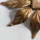Vintage gold metal mirror with leaves from the 1950s.