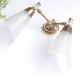 Pair of wall sconces in gold metal and plexiglass, 50 years