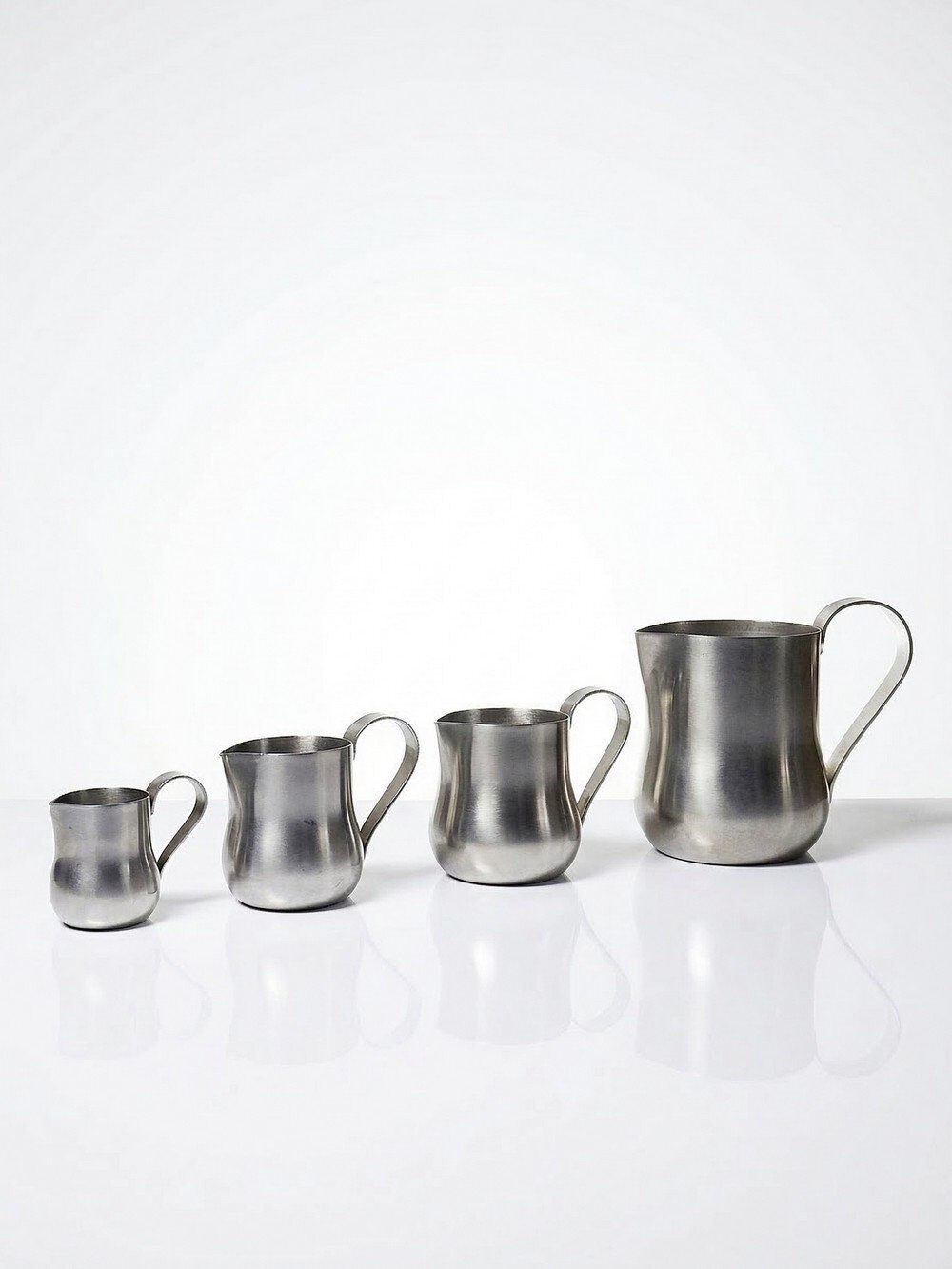 Set of 4 vintage bar measures in brushed stainless steel from the 60s-70s.