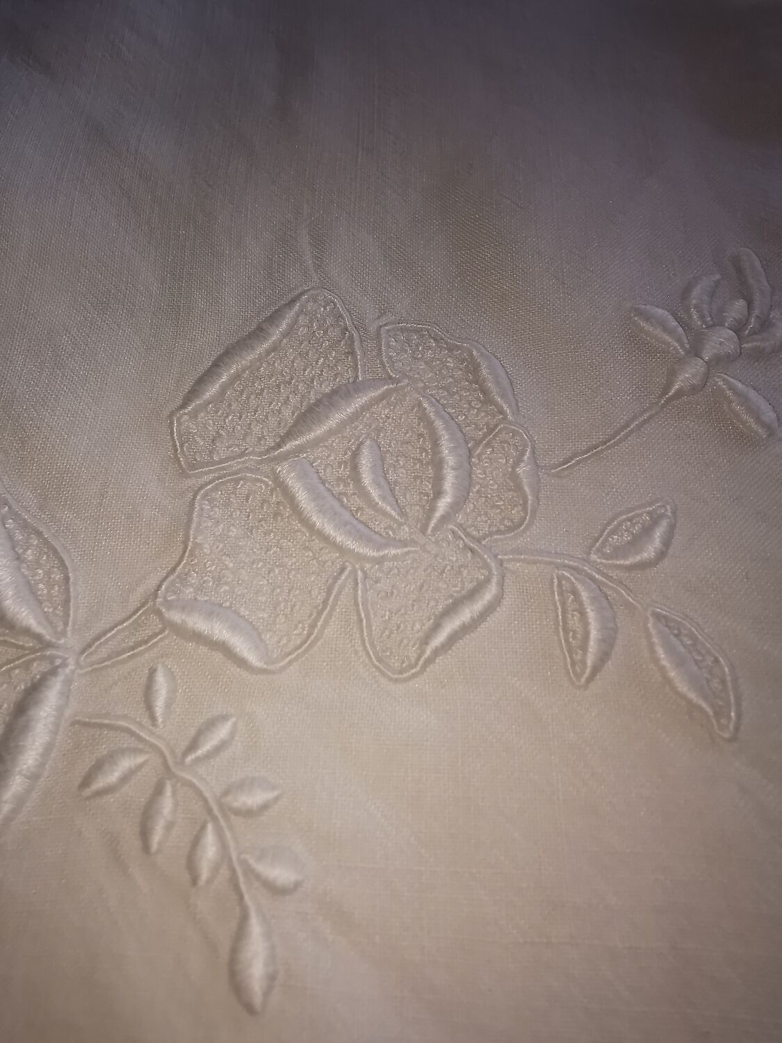 Antique embroidered linen sheet with a monogram.