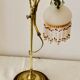 Old lamp adjustable on foot tulip golden brass.