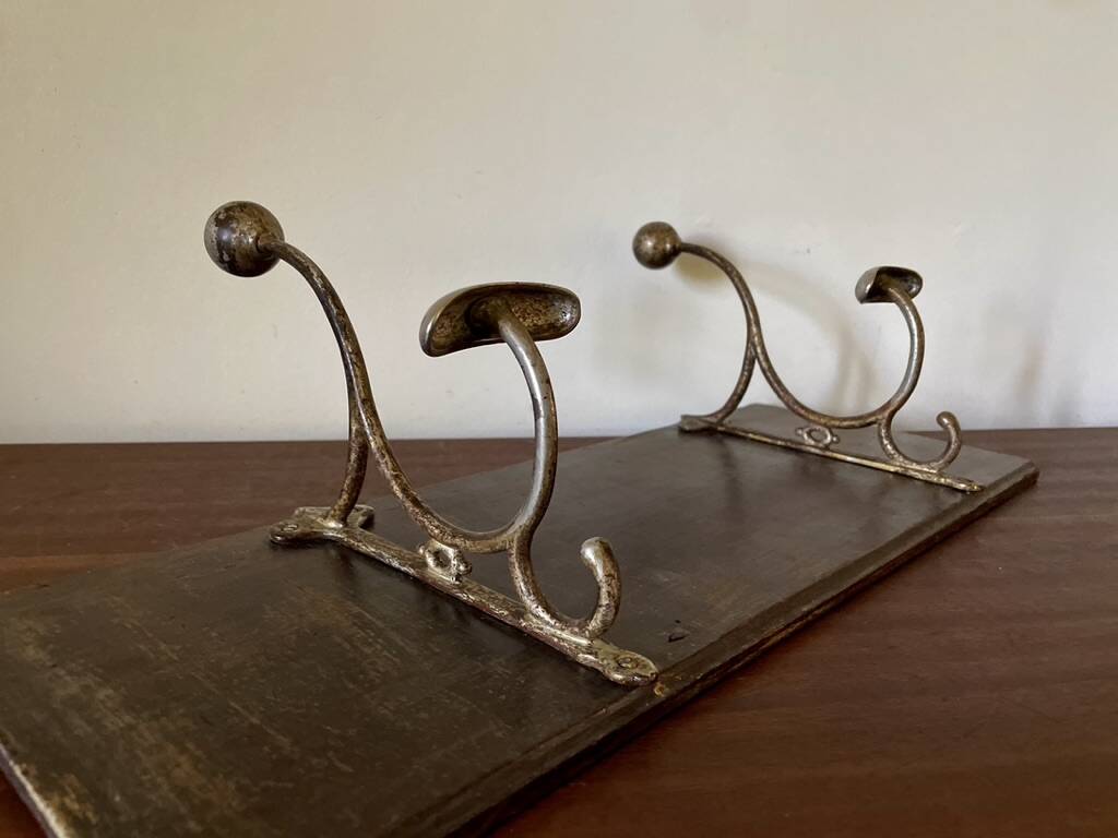 Patinated wood and metal coat rack from the 1950s.