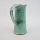Large green ceramic pitcher with leopard enamel