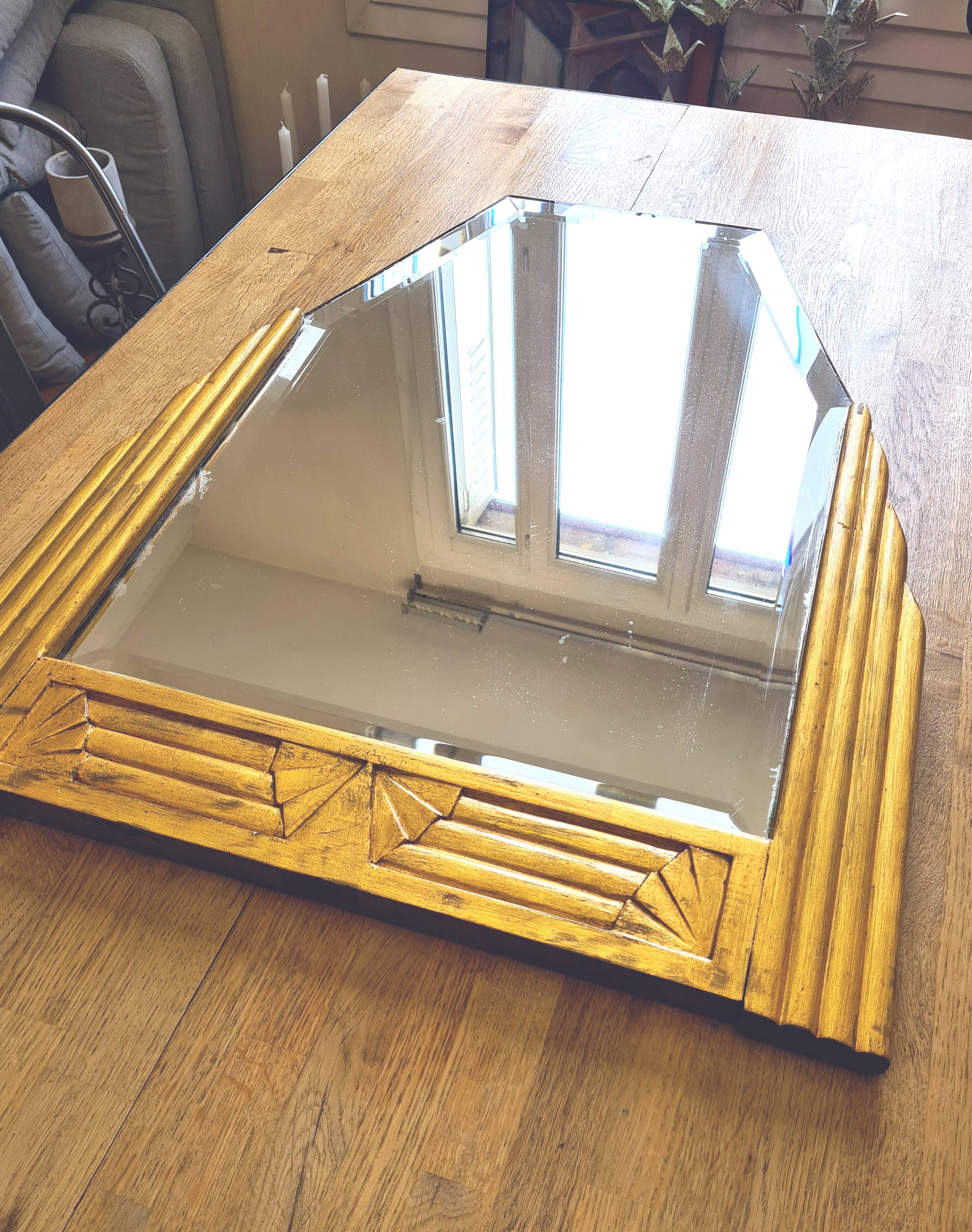 Antique Art Deco mercury mirror, in carved wood with gold leaf.