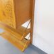 Wall shelf library with vintage light wood secretary bar