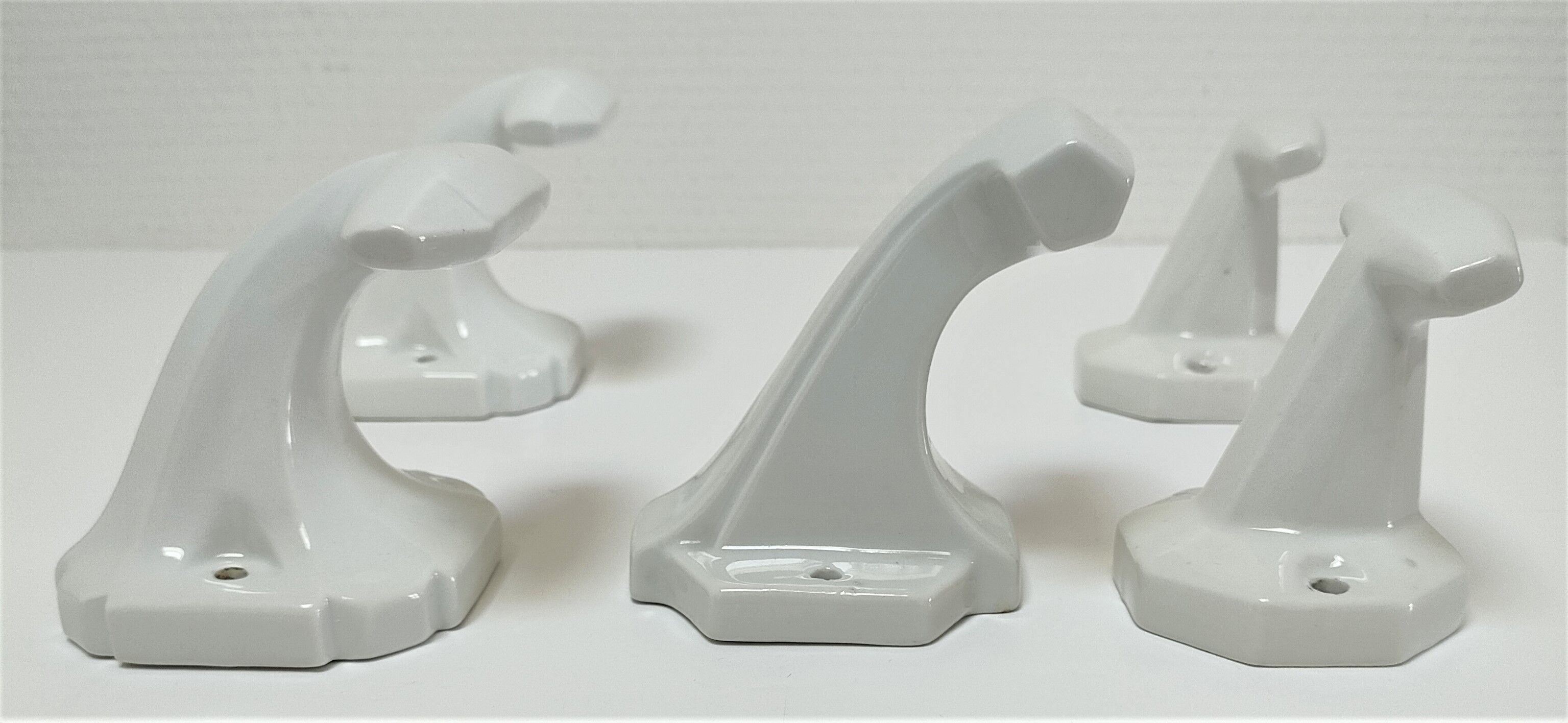 Five art deco white porcelain hooks