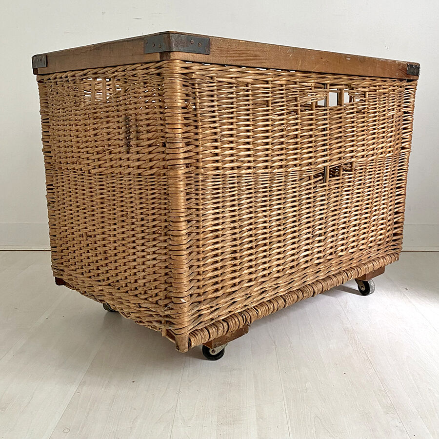 Old large wicker laundry basket on wheels