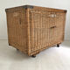 Old large wicker laundry basket on wheels