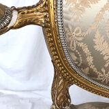 Carved and gilded wooden armchair in Louis XVI style, circa 1900