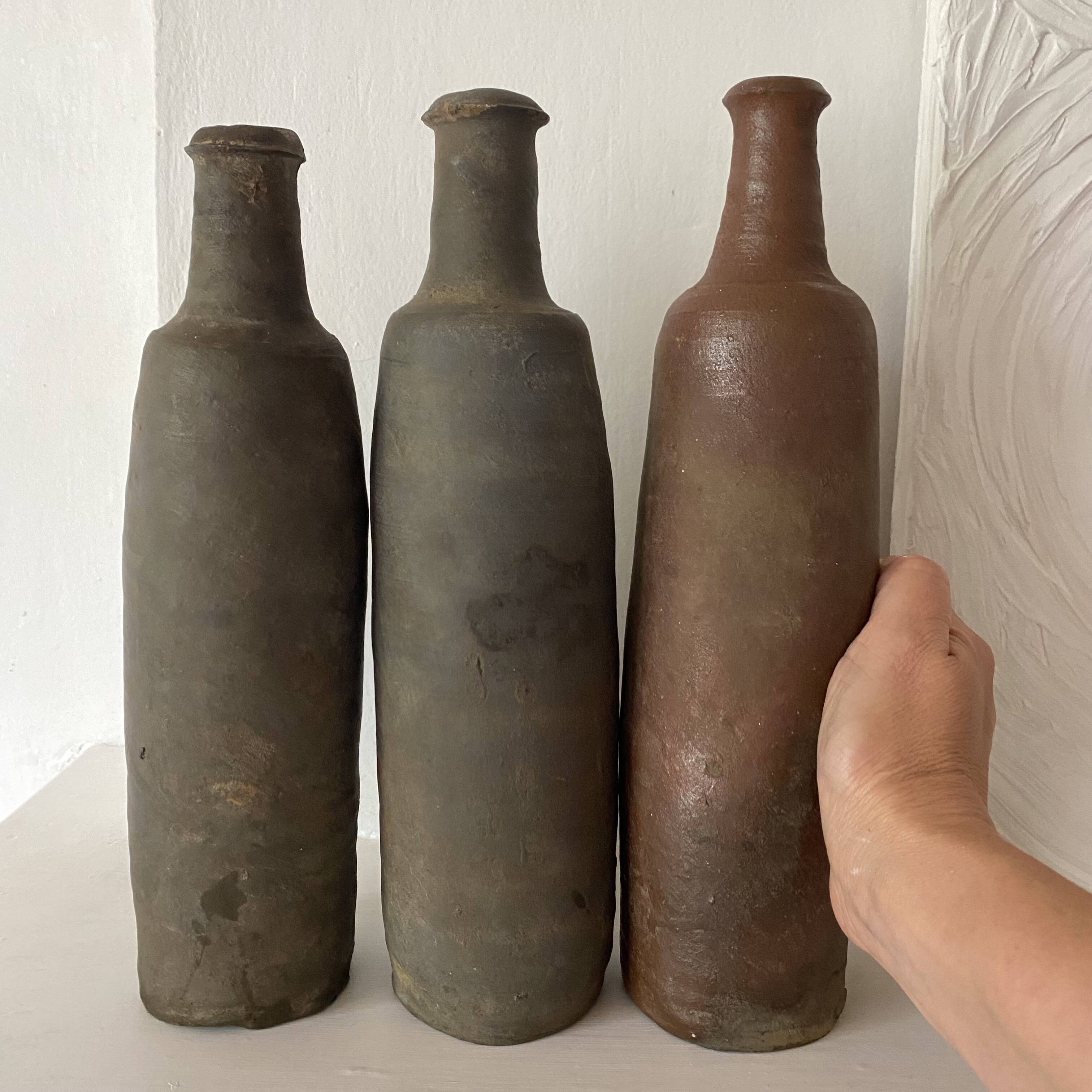 Antique terracotta cider bottles