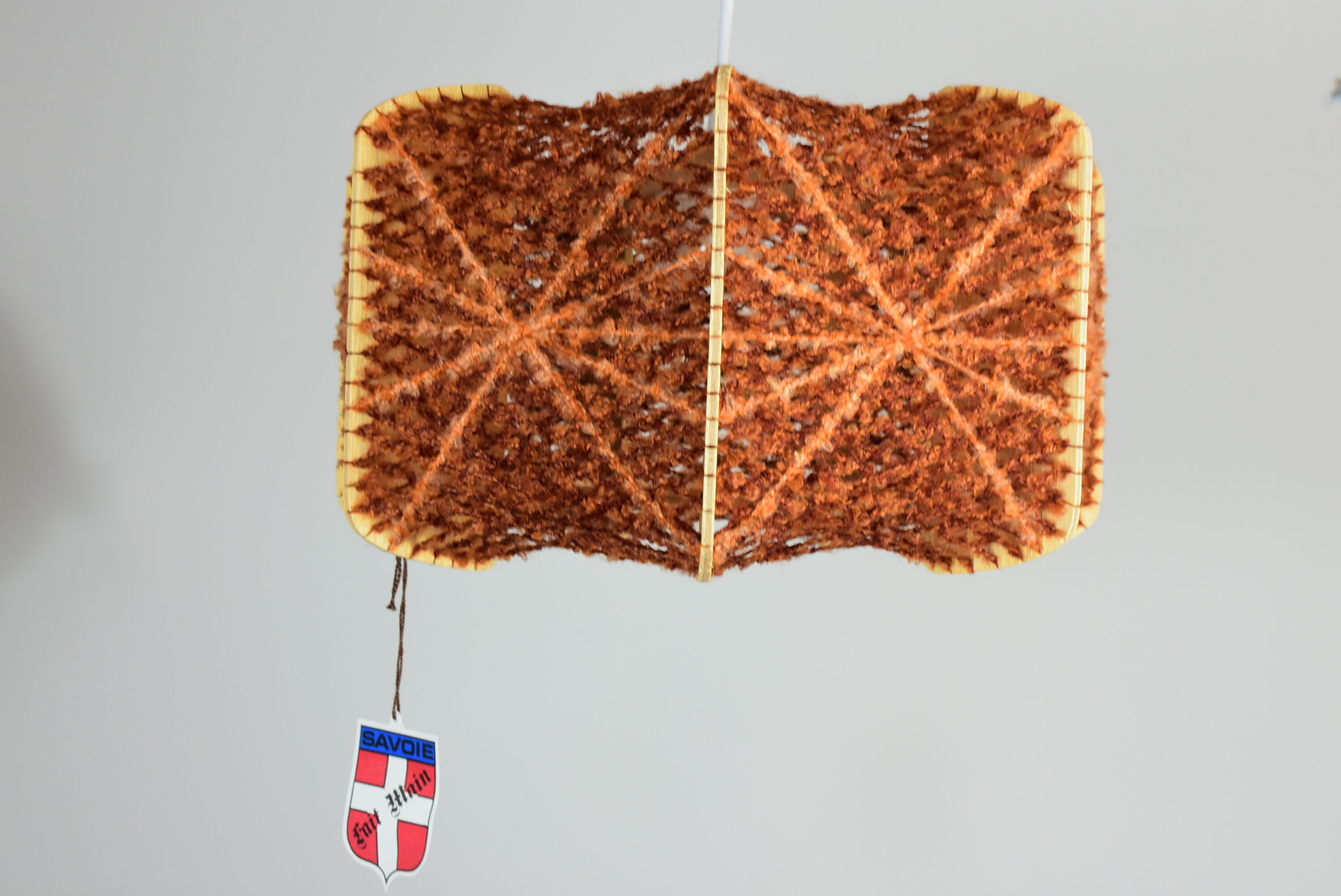 Brown wire and wood pendant light.