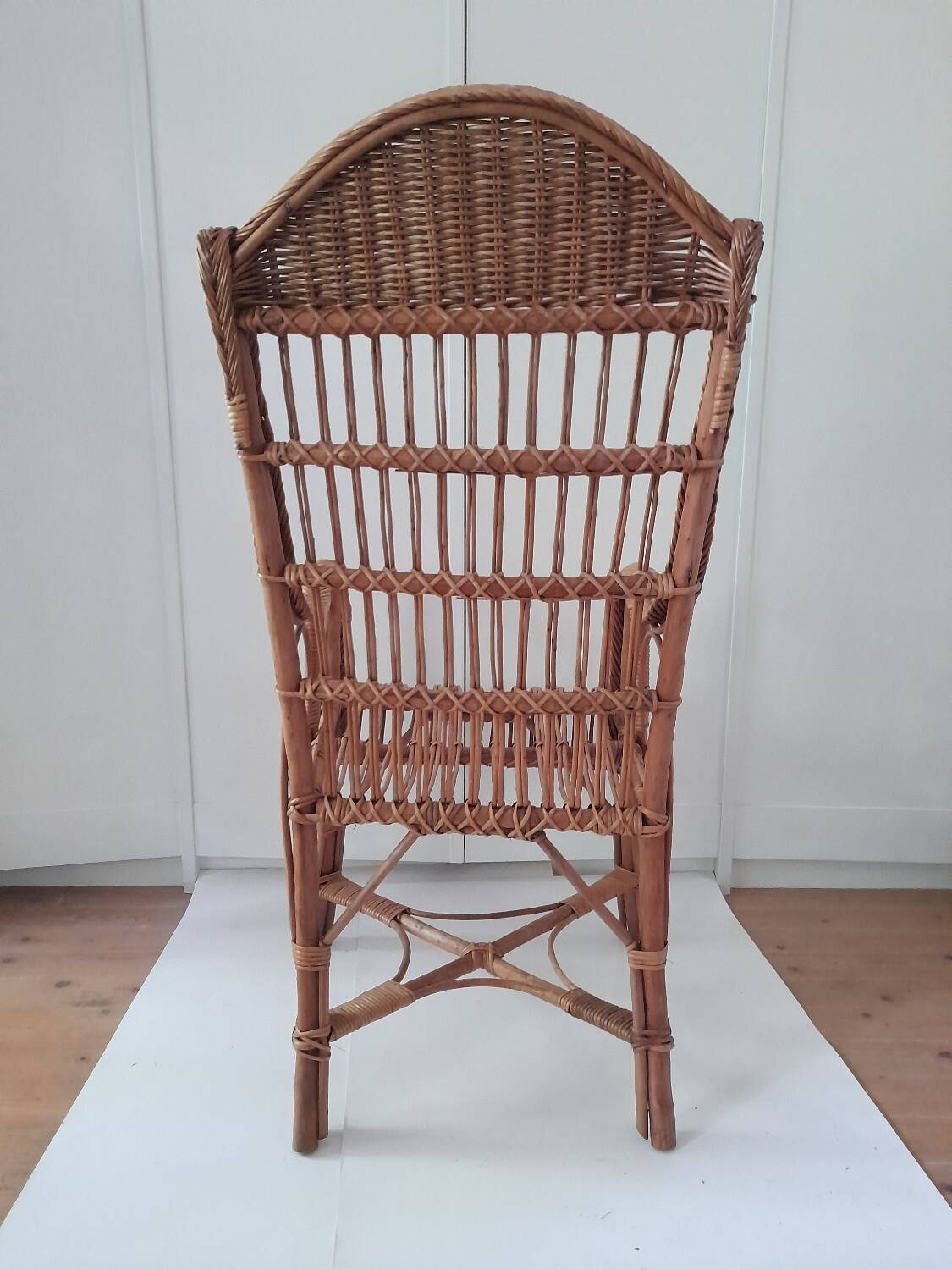 High-backed wicker armchair