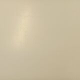 Vintage Eames round table for Vitra in white melamine, wood, and metal.