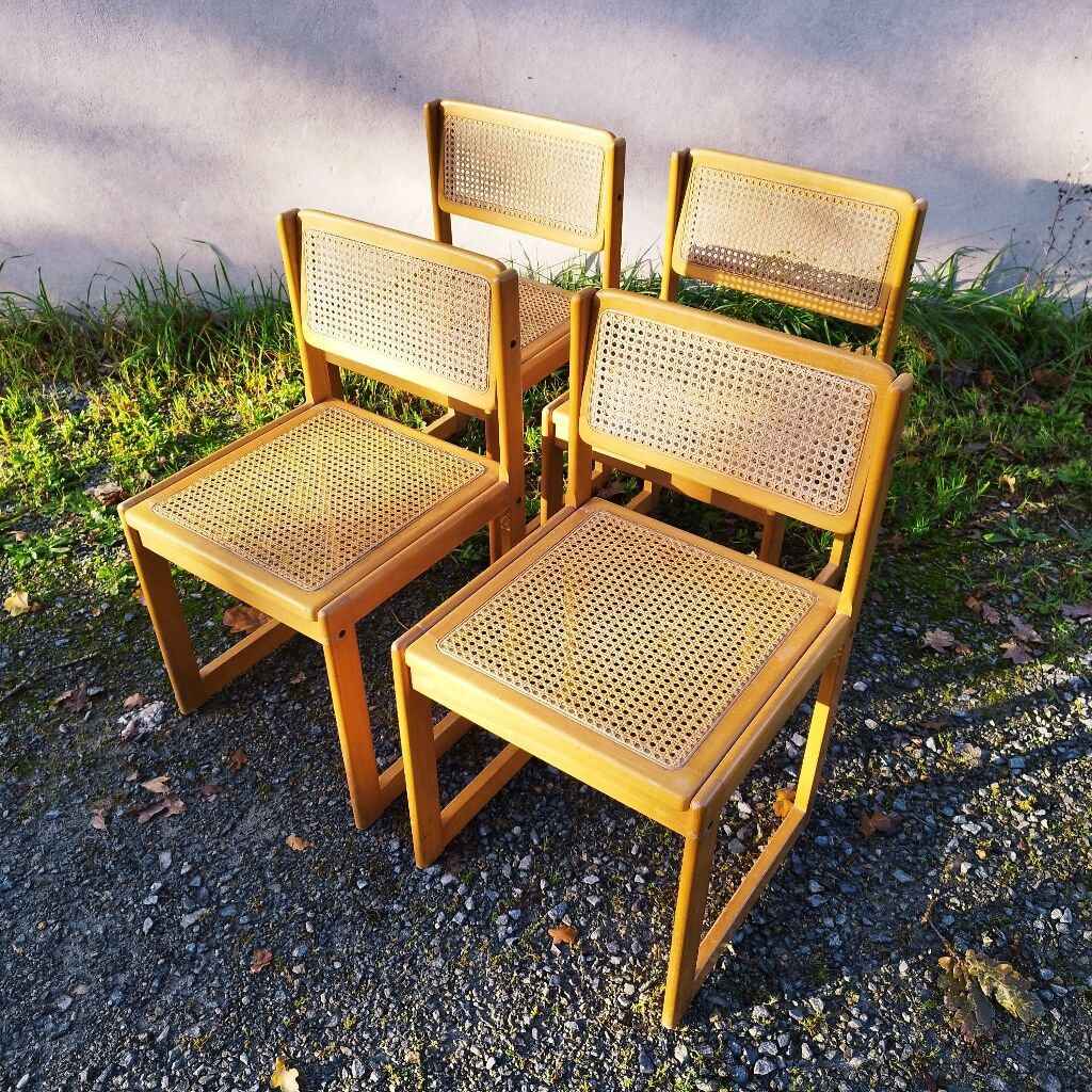 Four trendy tanned wooden chairs