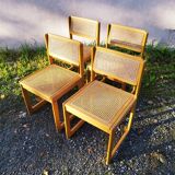 Four trendy tanned wooden chairs