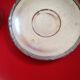 Silver-plated cup and saucer.