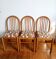 Three vintage-style pine and fabric chairs