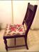 Wooden chair with embroidered seat
