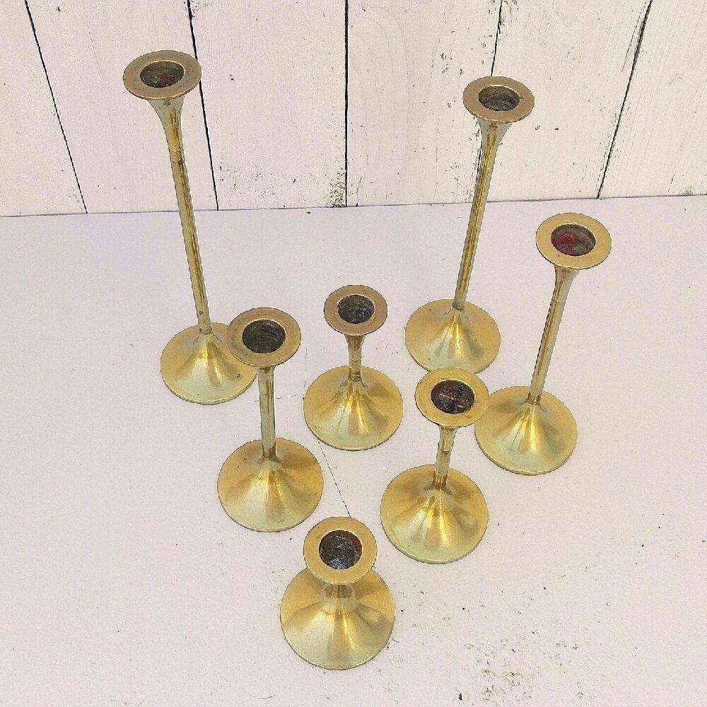 Seven candle holders in golden brass vintage trend