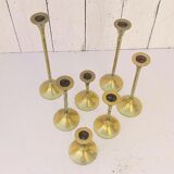 Seven candle holders in golden brass vintage trend